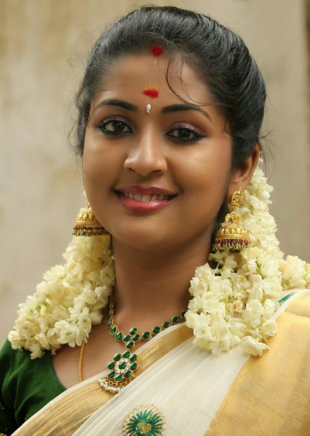 Malayalam Actress Navya Nair Smiling Stills In White Saree 